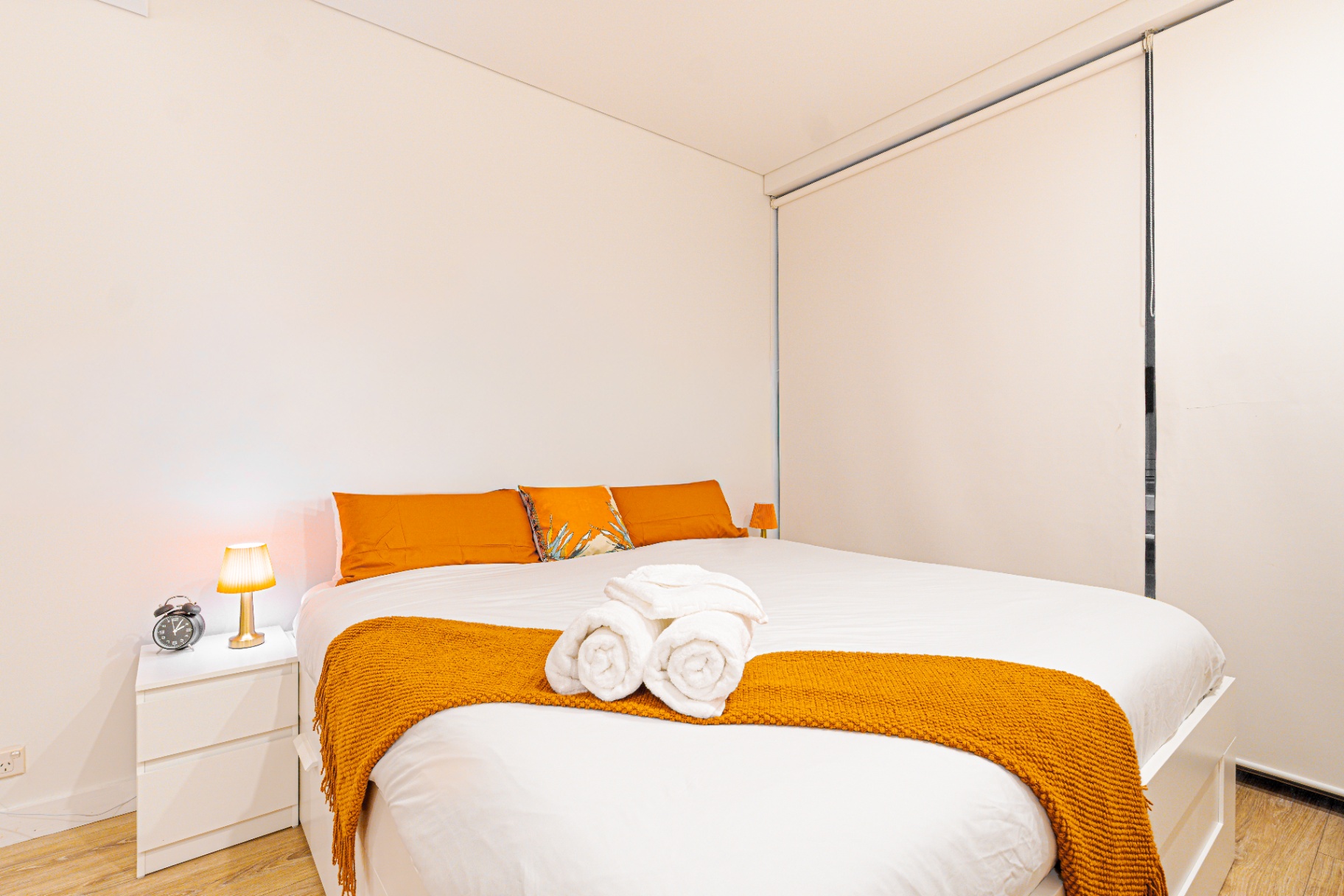 Bedroom with warm lamp and orange accents